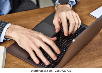 Male hands typing on a laptop keyboard