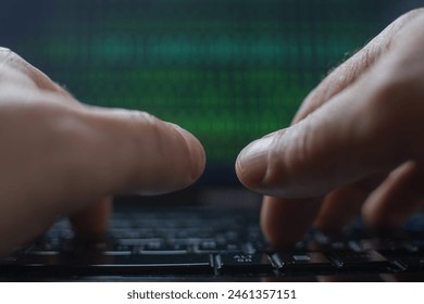 Male hands typing on a laptop keyboard with a green binary code in the background - Powered by Shutterstock