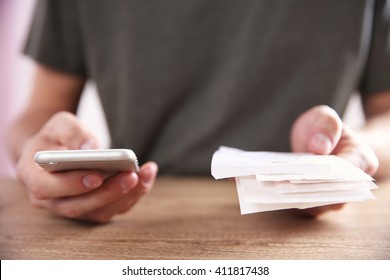 Male hands using calculator apps at the table