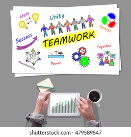 Male hands using tablet in front of teamwork concept