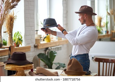 Male Hats Maker Standing At His Atelier Workshop, Holding Perfectly Made Hat For Customers. Successful Adult Business Man Employed At His Own Business