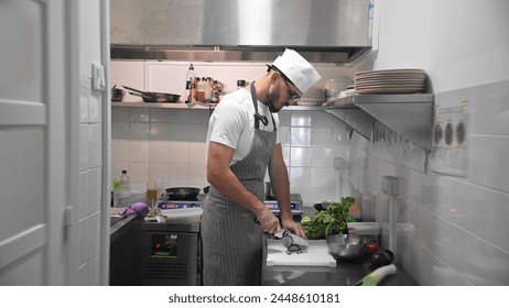 Male head chef prepare tasty fresh dish. Man cook meal restaurant kitchen. Young adult person work at cafe cuisine wear white hat. Guy make diet lunch food. Culinary worker job. Cookery staff uniform. - Powered by Shutterstock