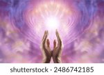 Male healer working with feminine heart energy - male hands with finger tips touch a white starlight against a pink peach lilac ethereal energy background with space for a spiritual message
