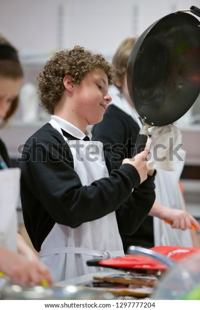 Male\
high school student cooking in home economics\
class