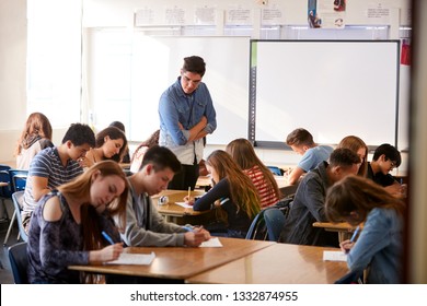 Male High School Teacher Standing By Interactive Whiteboard Teaching Lesson - Shutterstock ID 1332874955