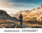 Male hiker hiking with enjoying the French Alps scenic and massif Des Cerces on autumn wilderness in Claree Valley at Hautes Alpes, France