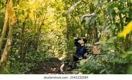 Male Hiker Resting and Enjoying Nature's Beauty. Harmony in Nature: Peaceful Mountain Forest Scenery. - Powered by Shutterstock