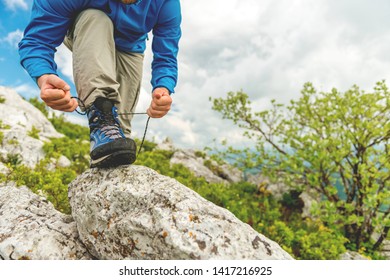 Male Hiker Tying Boot Laces - Powered by Shutterstock