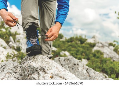 Male Hiker Tying Boot Laces - Powered by Shutterstock