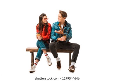 male hipster with paper cup of coffee pointing to girlfriend sitting on bench isolated on white - Powered by Shutterstock