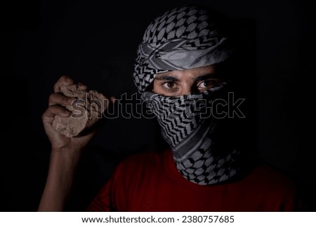 male holding stone to fight against occupation till freedom for his country palestine while wearing white keffiyeh Stock photo © 