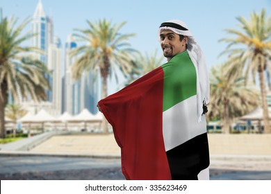 Male Holding UAE Flag Outdoors