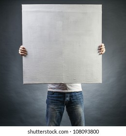 male holds a square canvas primed - Shutterstock ID 108093800