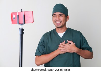 Male Hospital Nurse Giving Online Consultation With Patient Using Mobile Phone Video Call