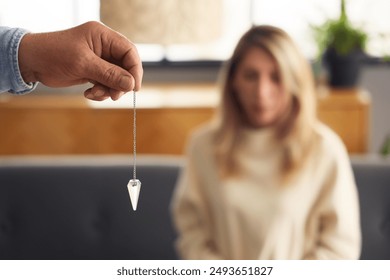 Male hypnotist with pendulum in office, closeup - Powered by Shutterstock