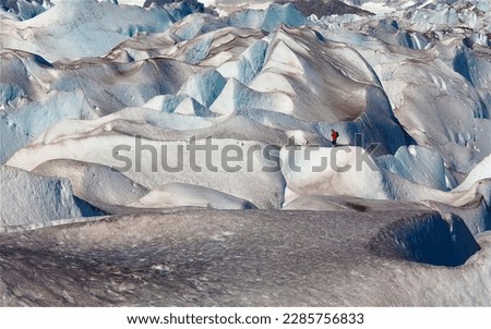 Male ice hiker in red jacket in profile on Mendenhall Glacier, Juneau, Alaska