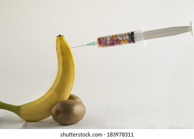 Male impotence metaphor: banana,kiwi and syringe with pills. Erectile dysfunction problems can be solved by medicine but some solutions are painful or temporary and risky because of side effects. 