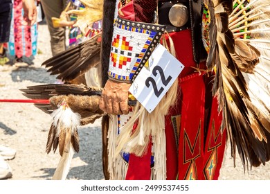 Male Indigenous dancer traditional regalia. Pow Wow powwow annual event. Headdress feathers beadwork. First Nations Native American Indian culture heritage pride. Close up detail hand  arm. Reserve. - Powered by Shutterstock