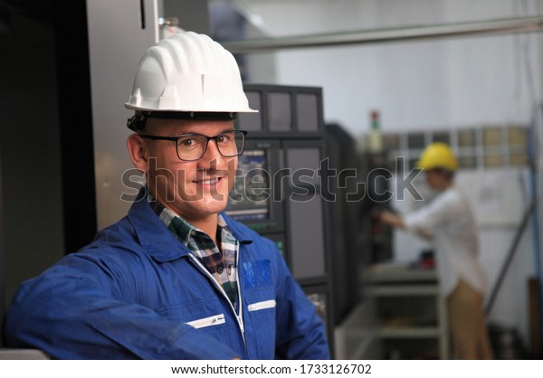 Male\
Industrial Engineers with  machine. Assist production engineer in\
industry. He checking or push metalwork control in industrial In a\
plastic factory for car. Concept Successful of\
Work.