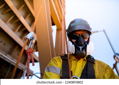 Male Industrial Rope Access Welder Wearing P3 Dust Mask Mandatory PPE  Protection Safety Body Harness, Helmet Equipment Prior Performing Maintenance Welding Repair Work On Construction Site, Perth   
