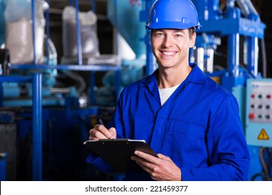 male industrial technician working inside a factory - Powered by Shutterstock