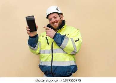 Male industrial worker with phone. Bearded engineer with white hard hat helmet. Climber