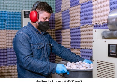 Male Industrial Worker With Protective Mask And Hearing Protectors In A Room For Material Testing