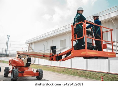 Male industry working at high in a boom liftinspection tank silo stainless