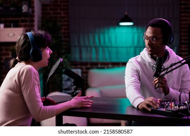 Male influencer hosting podcast livestream with woman, recording online conversation for social media content. Lifestyle blogger meeting with female guest to broadcast channel interview.