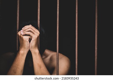 Male Inmate In Prison Lift Hand To Make A Wish And Pray On Black Background.concept For Prisoner,sadness,detain,erroneousness