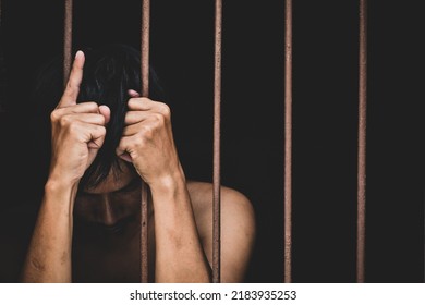 Male Inmate In Prison Lift Hand To Make A Wish And Pray On Black Background.concept For Prisoner,sadness,detain,erroneousness