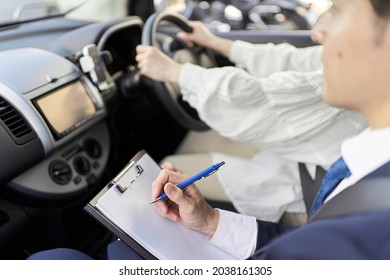 Male Instructor Teaching Car Driving