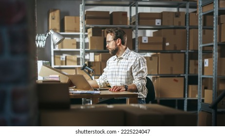 Male Inventory Manager Using Laptop Computer in Storeroom, Communicating with Clients, Writing Down Projects. Stylish Small Business Owner Working in Warehouse, Fulfilling Orders for Customers. - Powered by Shutterstock