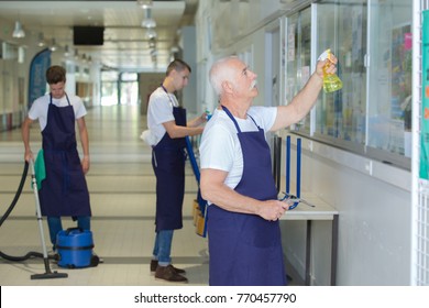 Male Janitorial Staff Cleaning The Establishment