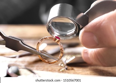 Male jeweler examining ruby ring in workshop, closeup view - Shutterstock ID 1510567001