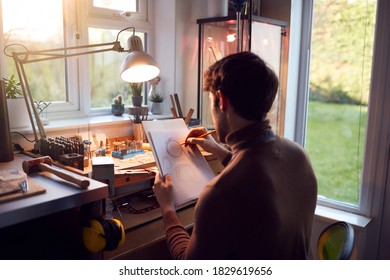 Male Jeweller Sketching Out Design For Ring In Studio - Powered by Shutterstock