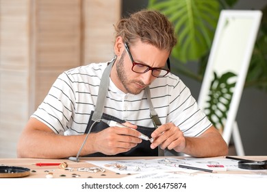 Male Jewelry Designer Working In Office