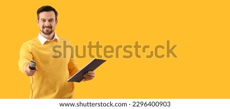 Male journalist with microphone and clipboard on yellow background with space for text