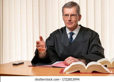 Male judge sitting at a desk speaking severely