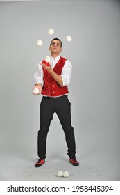 A Male Juggler In A Dracula Costume Juggles Balls. Juggler's Day 