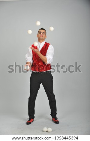 A male juggler in a dracula costume juggles balls. Juggler's day 
