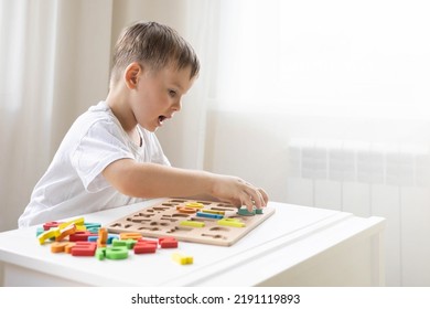 Male Kid Playing With Wooden Eco Friendly Alphabet Letters Board On Table Top View. Intellectual Game Preschool Primary Education Early Development Font Characters For Learning Reading And Writing