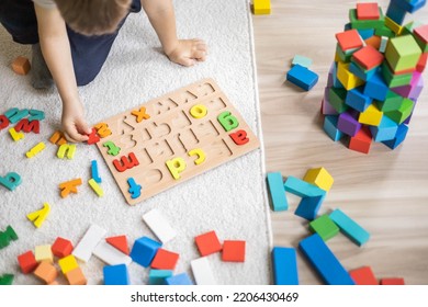 Male Kid Playing With Wooden Eco Friendly Alphabet Letters Board On Table Top View. Intellectual Game Preschool Primary Education Early Development Font Characters For Learning Reading And Writing