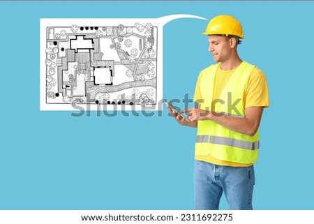 Male landscape designer with tablet computer on light blue background  