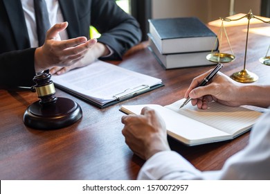 Male Lawyer Discussing Negotiation Legal Case With Client Meeting With Document Contact In Courtroom, Law And Justice Concept.