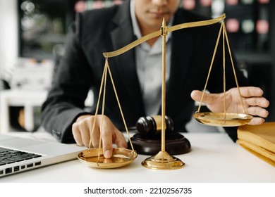 Male Lawyer In The Office With Brass Scale On White Table. Justice And Law Concept 