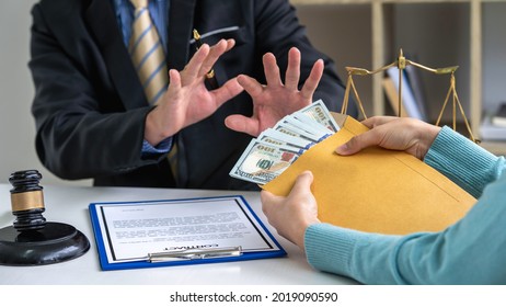 Male lawyer rejects bribes offered by businesswoman To allow lawyers to help form illegal cases in court, bribes corruption illegal fraud bribery concept. - Shutterstock ID 2019090590