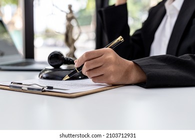 A male lawyer is signing a plea agreement with a client in a fraud case, in which the client has filed a lawsuit against an employee at a company that commits the fraud. Fraud litigation concept.