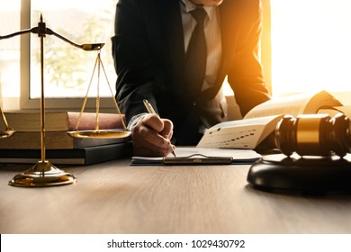 Male lawyer working with contract papers and wooden gavel on tabel in courtroom. justice and law ,attorney, court judge, concept. - Shutterstock ID 1029430792