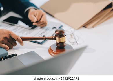 Male lawyer working with contract papers and wooden gavel on tabel in courtroom. justice and law ,attorney, court judge, concept. - Powered by Shutterstock